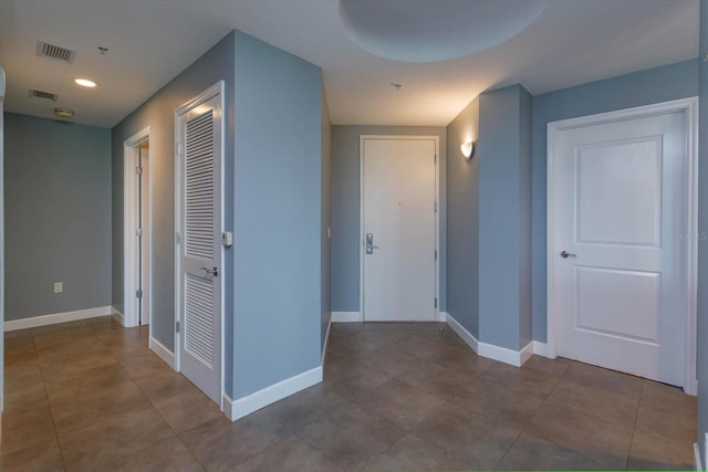 corridor with dark tile flooring