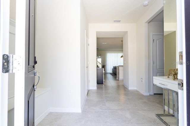 corridor with light tile floors