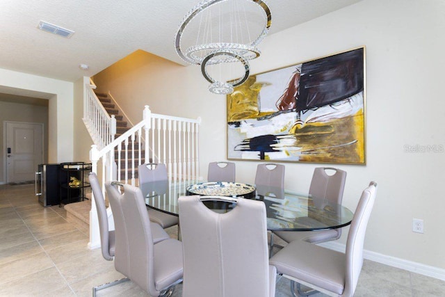 tiled dining space with an inviting chandelier