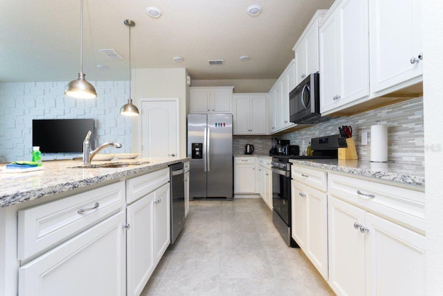 kitchen with appliances with stainless steel finishes, sink, tasteful backsplash, decorative light fixtures, and light stone countertops