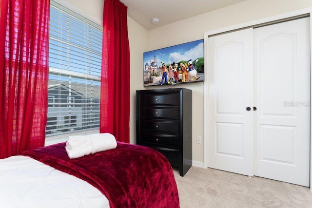 carpeted bedroom featuring a closet