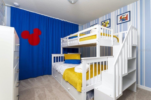 carpeted bedroom featuring a textured ceiling