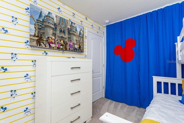 bedroom featuring carpet floors and a textured ceiling