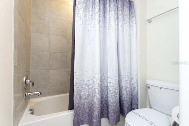 bathroom featuring shower / bath combination with curtain and toilet