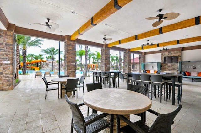 view of patio / terrace featuring ceiling fan and exterior bar