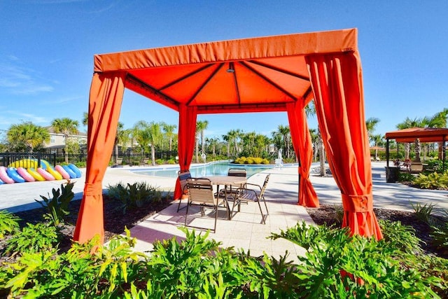 view of patio / terrace featuring a gazebo and a community pool