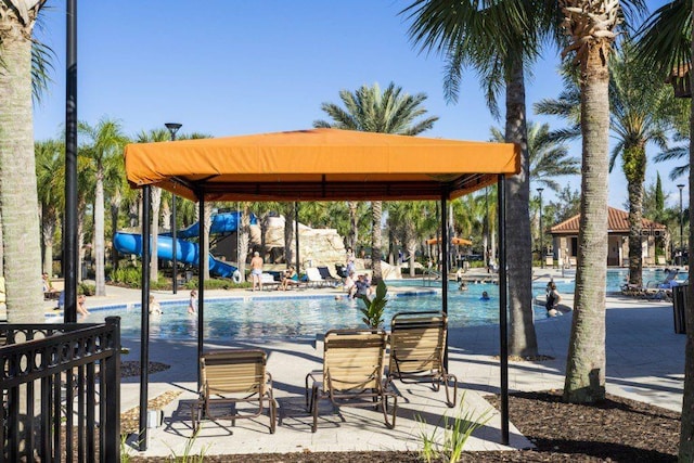 view of dock with a gazebo and a community pool