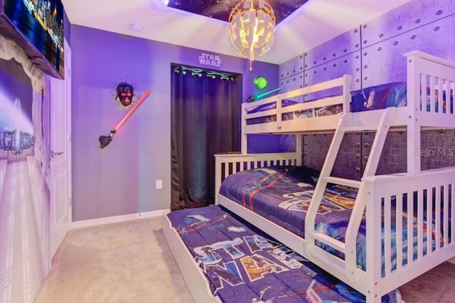 bedroom featuring carpet floors and an inviting chandelier