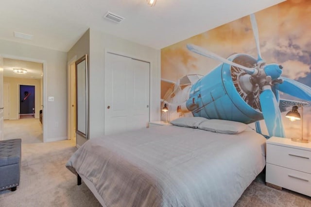 bedroom featuring light carpet and a closet