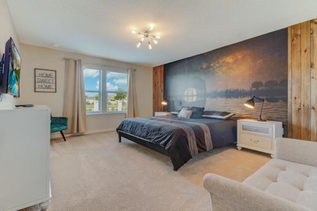 bedroom with light carpet and wood walls