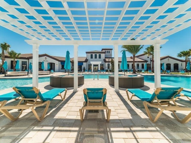 view of patio / terrace with a community pool and a pergola