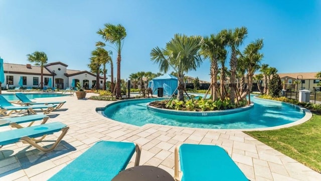 view of swimming pool with a patio