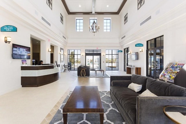 living room featuring ornamental molding, a high ceiling, dark tile floors, and beam ceiling