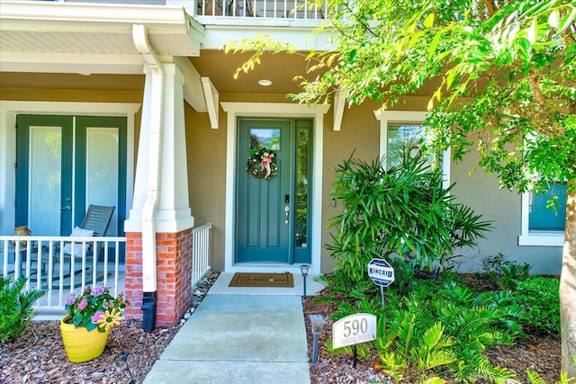 doorway to property featuring covered porch