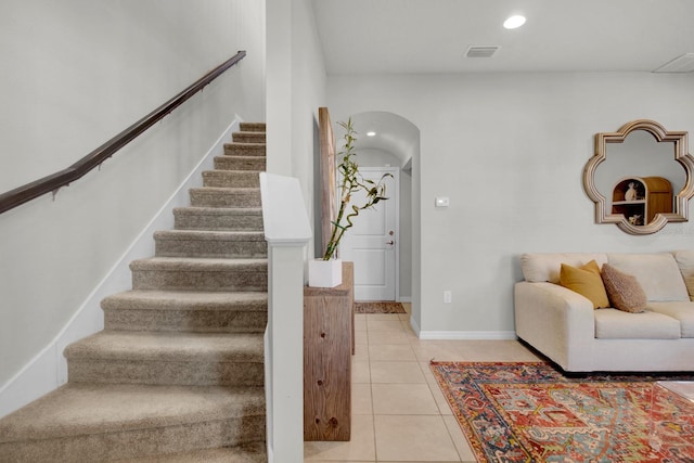 staircase featuring tile patterned floors