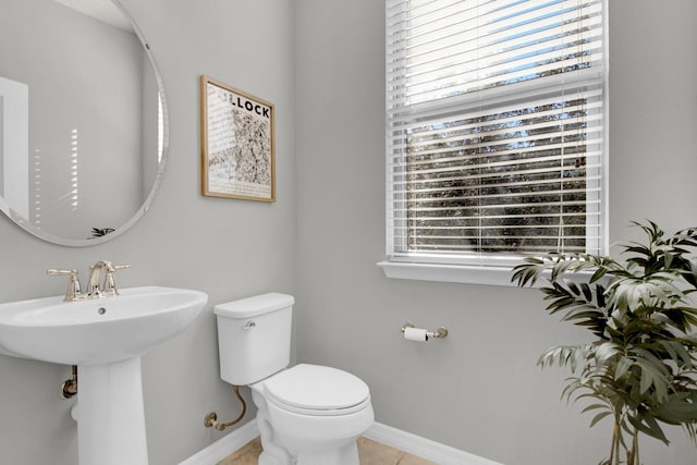 bathroom with tile patterned floors, toilet, and sink