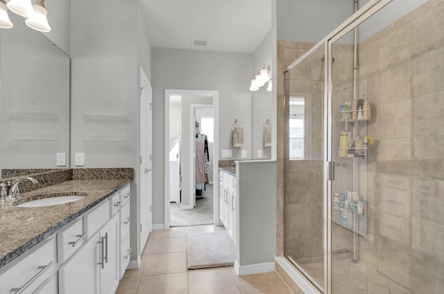 bathroom featuring tile patterned floors, vanity, and an enclosed shower