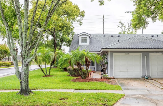 view of front of house with a front yard and a garage