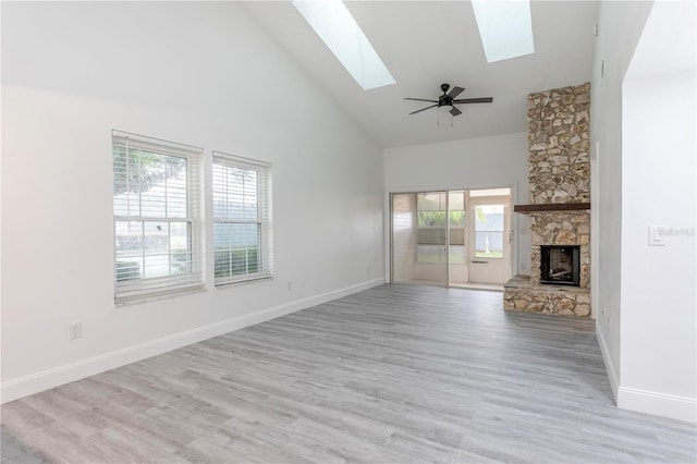 unfurnished living room with plenty of natural light, high vaulted ceiling, and light hardwood / wood-style flooring