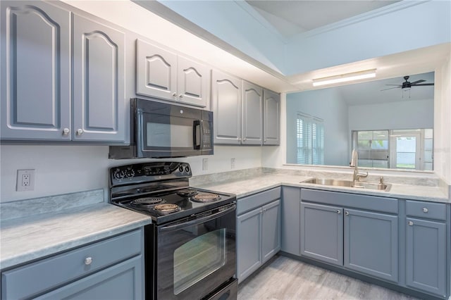 kitchen with ornamental molding, ceiling fan, sink, black appliances, and light hardwood / wood-style floors