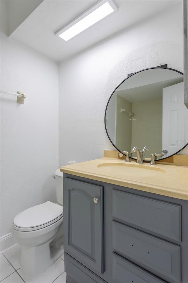 bathroom featuring tile patterned flooring, vanity, and toilet