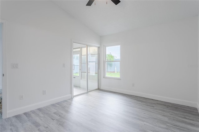 spare room featuring ceiling fan, vaulted ceiling, and light hardwood / wood-style flooring