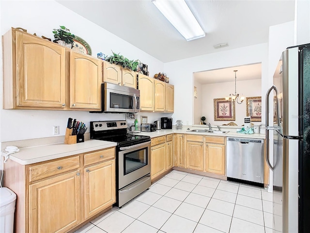 kitchen with appliances with stainless steel finishes, a chandelier, sink, pendant lighting, and light tile floors