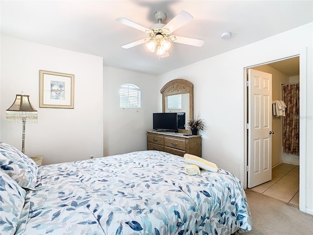 bedroom with ceiling fan and light carpet