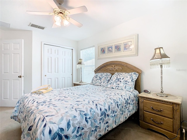 bedroom with a closet, dark colored carpet, and ceiling fan