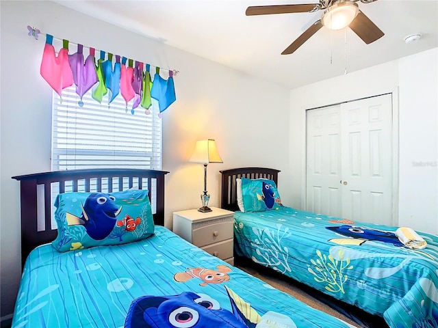 bedroom with ceiling fan and a closet