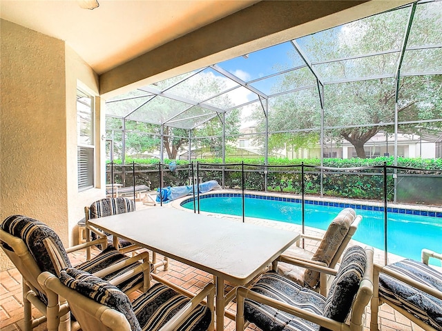 view of swimming pool featuring a patio area and a lanai