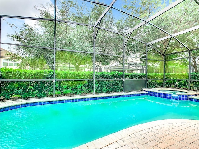 view of swimming pool featuring an in ground hot tub and a lanai