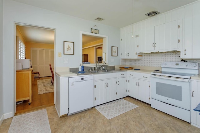 kitchen featuring sink, white cabinetry, white appliances, and light tile flooring