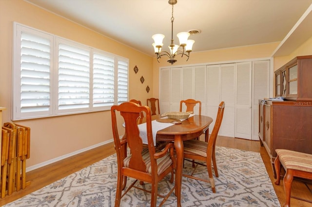 dining area featuring a chandelier and hardwood / wood-style flooring