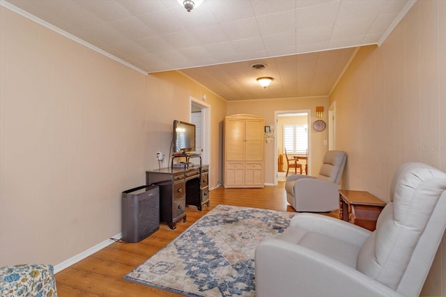 living room featuring ornamental molding and wood-type flooring