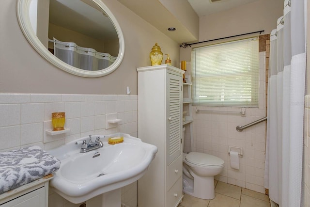 bathroom with tile walls, backsplash, tile floors, sink, and toilet