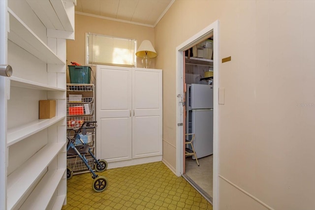 interior space with ornamental molding and light tile flooring