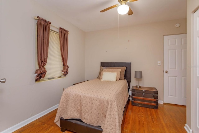 bedroom with ceiling fan and hardwood / wood-style floors