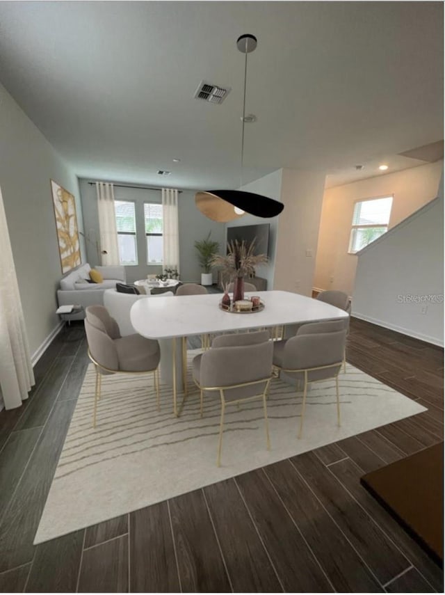 dining room featuring plenty of natural light and dark hardwood / wood-style floors