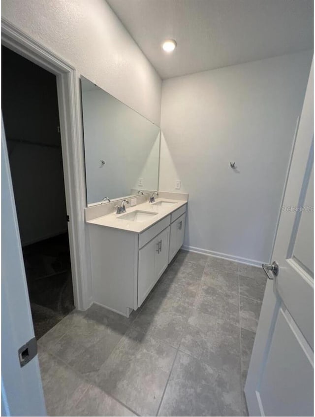 bathroom with double vanity and tile flooring