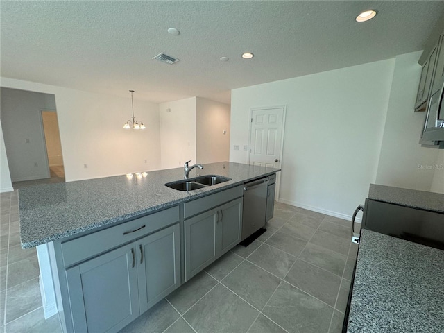 kitchen with tile flooring, sink, an island with sink, and stainless steel dishwasher