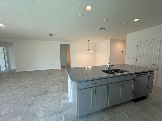 kitchen featuring a kitchen island with sink, hanging light fixtures, light tile floors, sink, and dishwasher