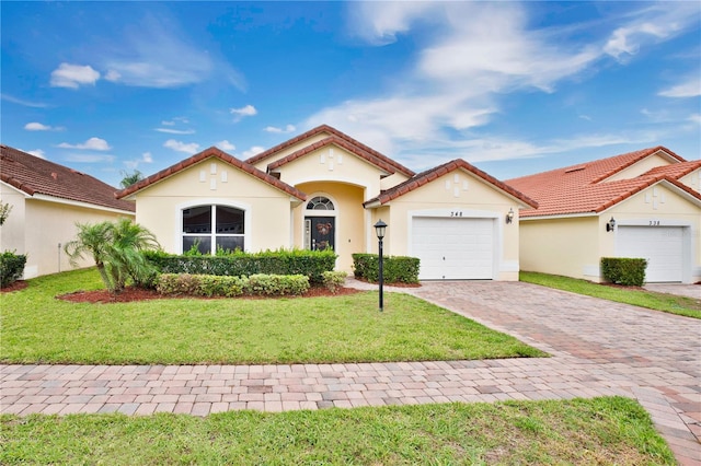 mediterranean / spanish-style house featuring a front lawn and a garage