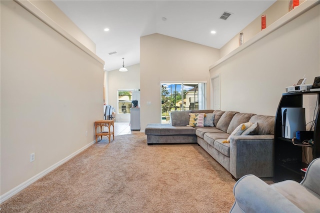 living room with high vaulted ceiling and carpet flooring