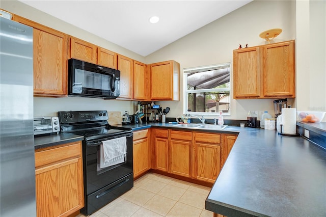 kitchen with sink, vaulted ceiling, light tile floors, and black appliances