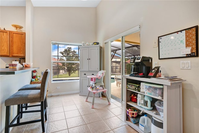 interior space featuring high vaulted ceiling and light tile floors