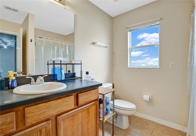 bathroom with large vanity, tile floors, and toilet