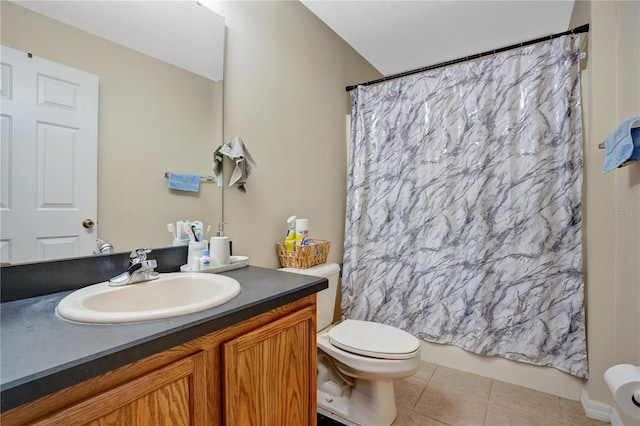 bathroom featuring tile flooring, vanity, and toilet