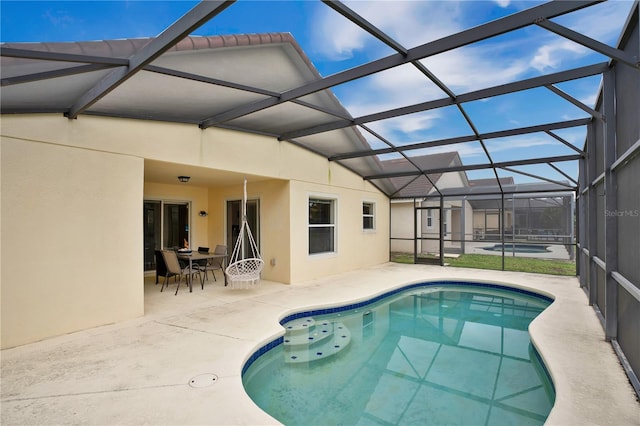 view of swimming pool featuring a patio area and a lanai