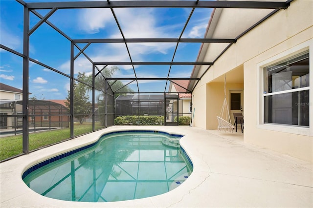 view of swimming pool with a patio and glass enclosure